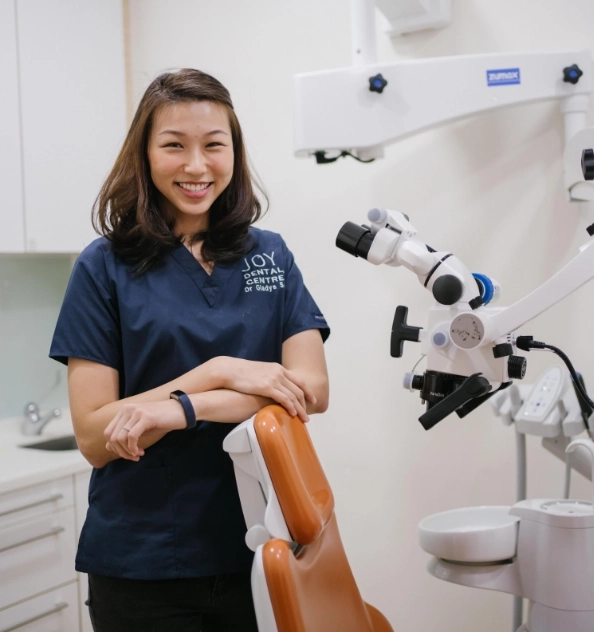 Dentist posing next to cutting edge electronic microscope.