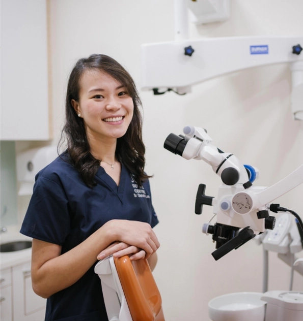 Dentist posing next to cutting edge electronic microscope.