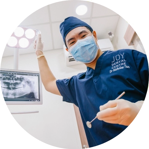 Shot from the patient's perspective, seated in the dentist chair: dentist is adjusting the light and holding his tools in preparation for an examination.