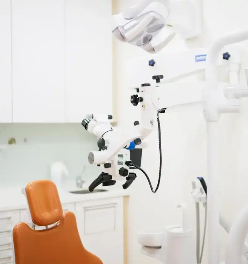 Modern dental chair and related dental equipment in office.