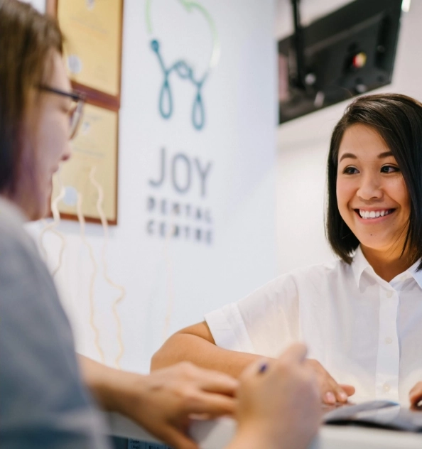 Patient welcomed by receptionist.